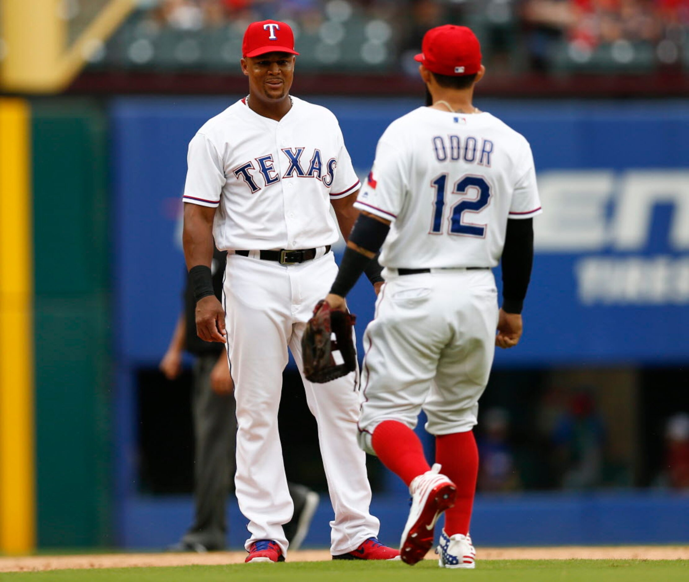 Texas Rangers third baseman Adrian Beltre, left, smiles as second baseman Rougned Odor (12)...