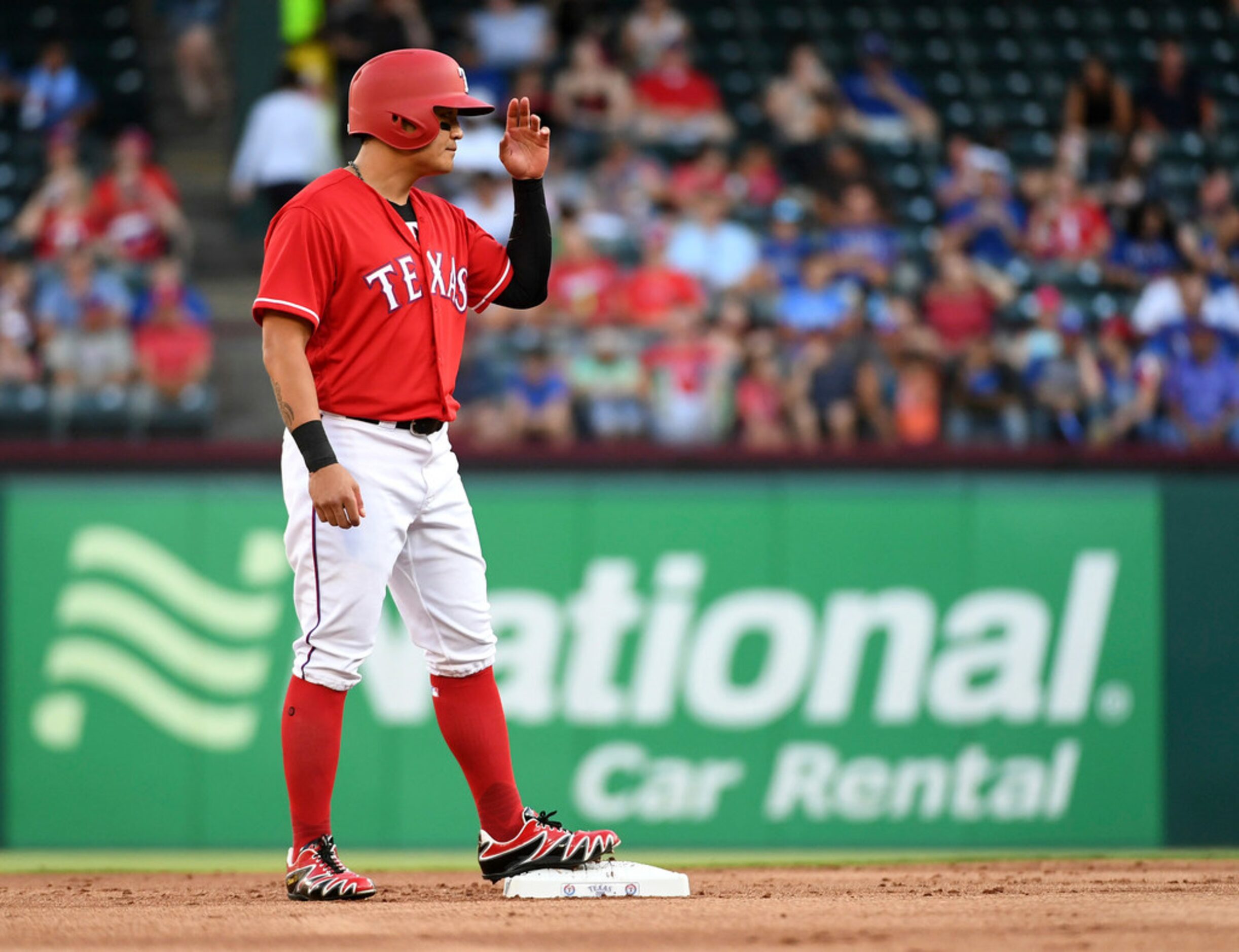 Texas Rangers' Shin-Soo Choo acknowledges the dugout after reaching second on a single by...