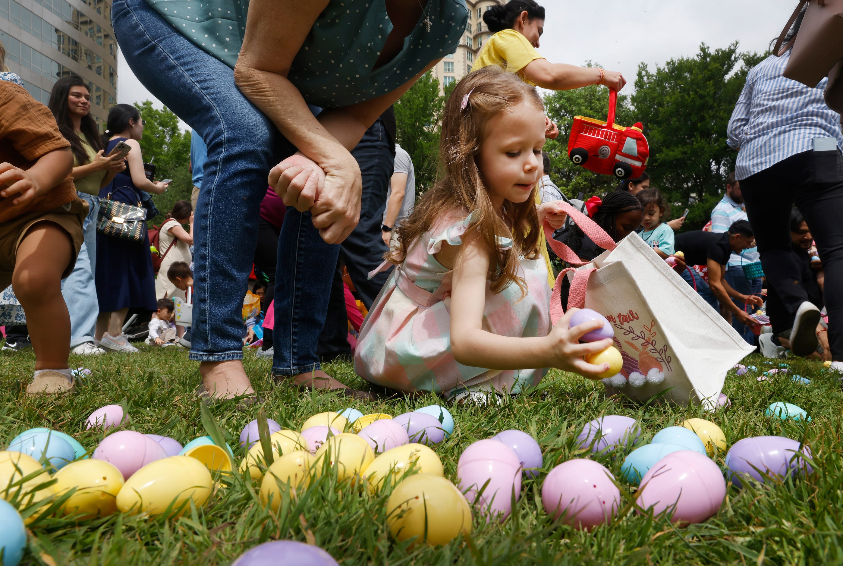 Children collect Easter eggs during a hunt at Easter in Turtle Creek Park in Dallas, March...