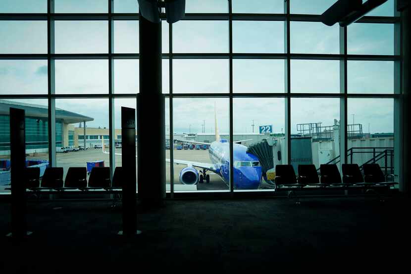 A Southwest Airlines 737-700 sits at a gate at Hobby Airport in Houston on Friday, March 20,...