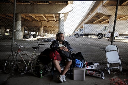 A man who called himself "J.R." sat with his belongings outside the now-gated Tent City in...