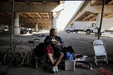 A man who called himself "J.R." sat with his belongings outside the now-gated Tent City in...