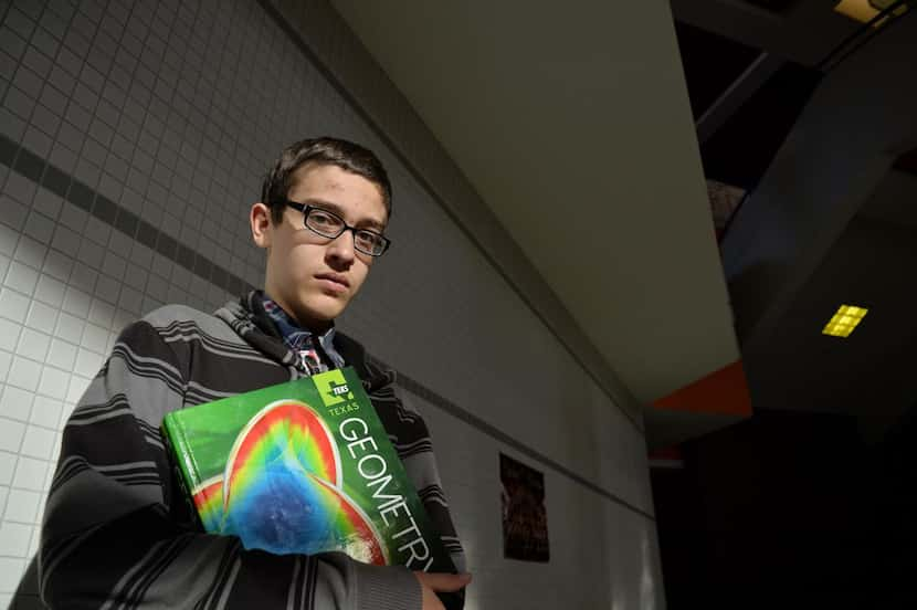 
Logan Tharp takes his  geometry textbook to  his pre-AP geometry class at Rockwall High...