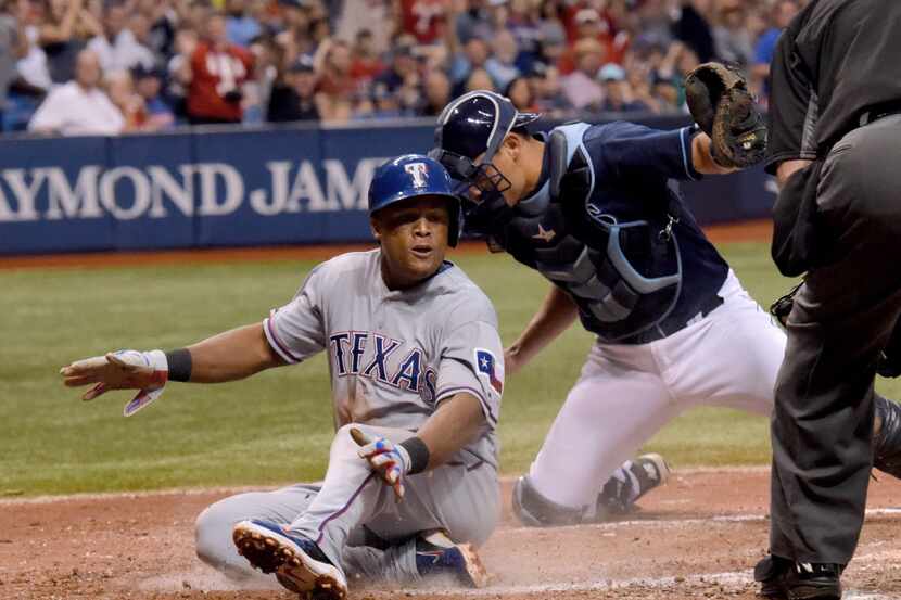 Texas Rangers third baseman Adrian Beltre (29) is tagged out by Tampa Bay Rays catcher Luke...