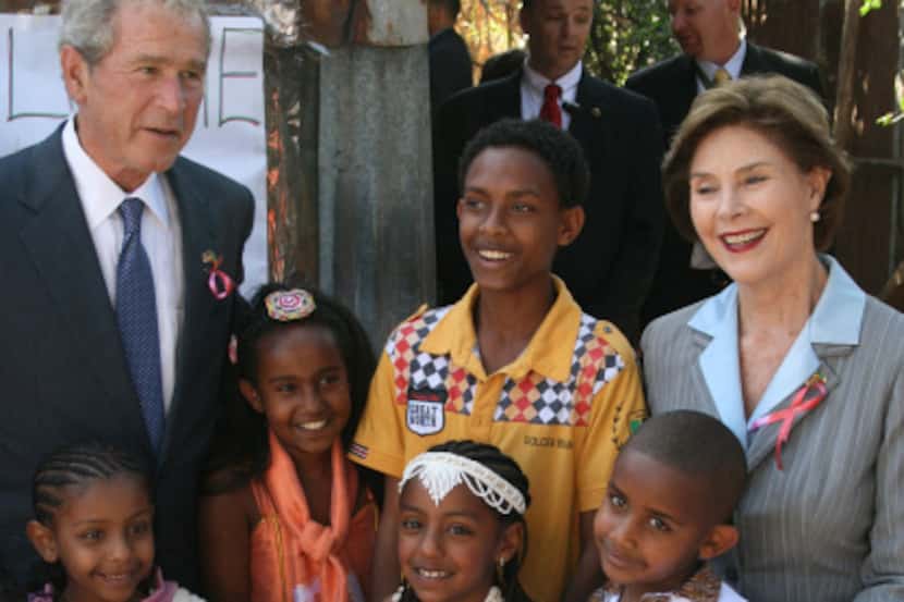 Former President George W. Bush and his wife, former first lady Laura Bush, visit a...