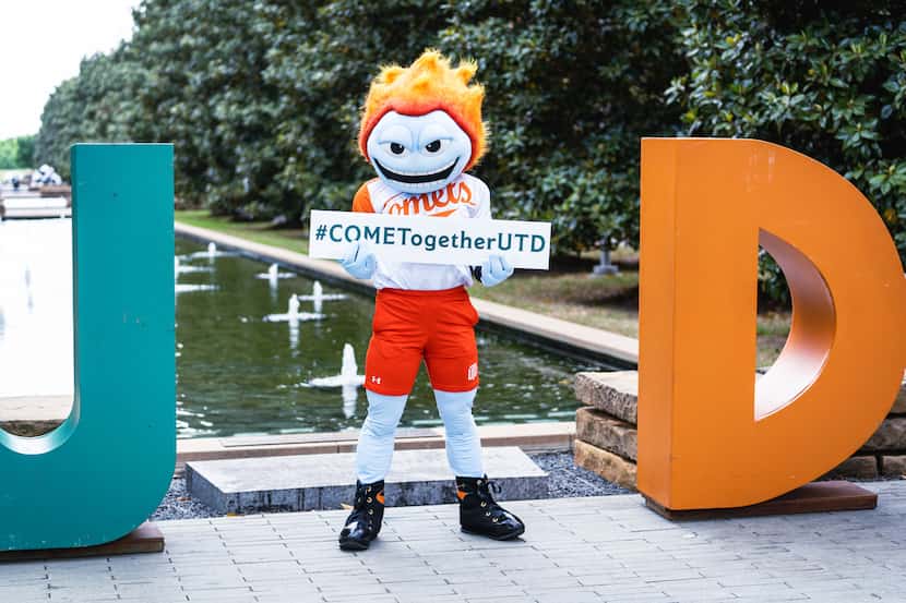 A school mascot representing the physical embodiment of a comet holds a sign that says...