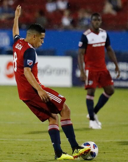 FC Dallas midfielder Victor Ulloa (8) passes the ball during the first half on a wet field...
