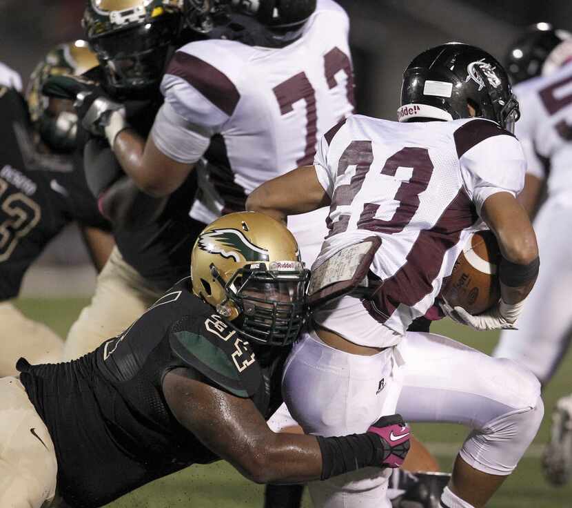 Mansfield Timberview Wolves running back Mason Miller (23) is tackled for a lose by DeSoto...