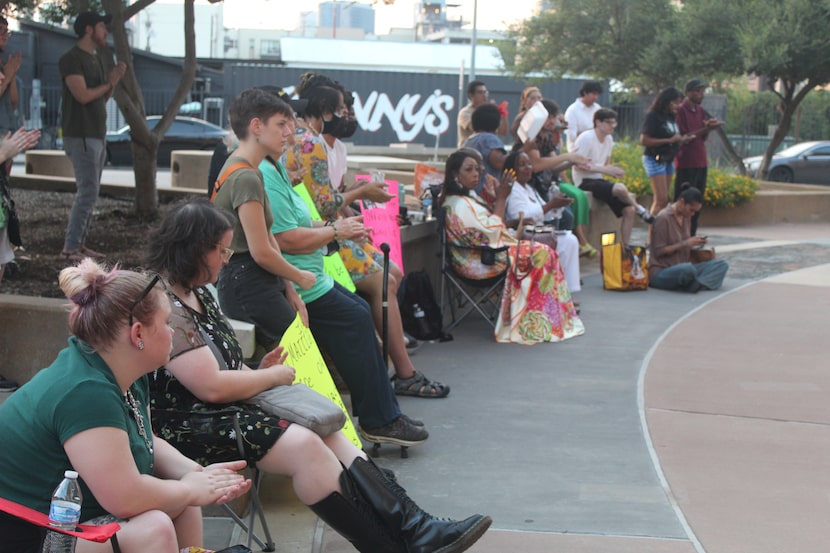 A crowd of protesters listen to activists speaking at Dallas Police Headquarters on August...