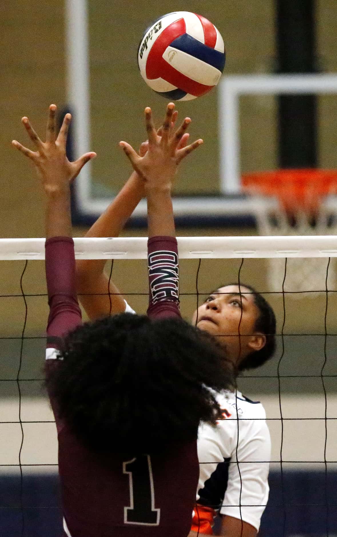 Sachse High School middle blocker Liz Woods tips the ball over Wylie High School middle...