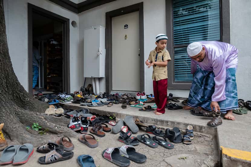 Rohingya refugees remove their shoes before entering a mosque inside an apartment complex in...