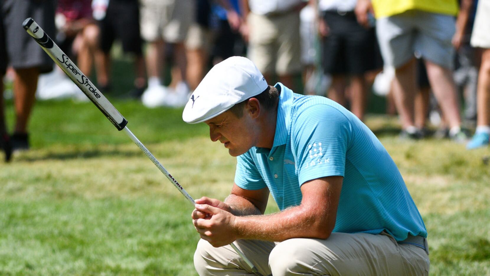 Bryson DeChambeau reacts after missing his putt on the ninth green during the first round of...