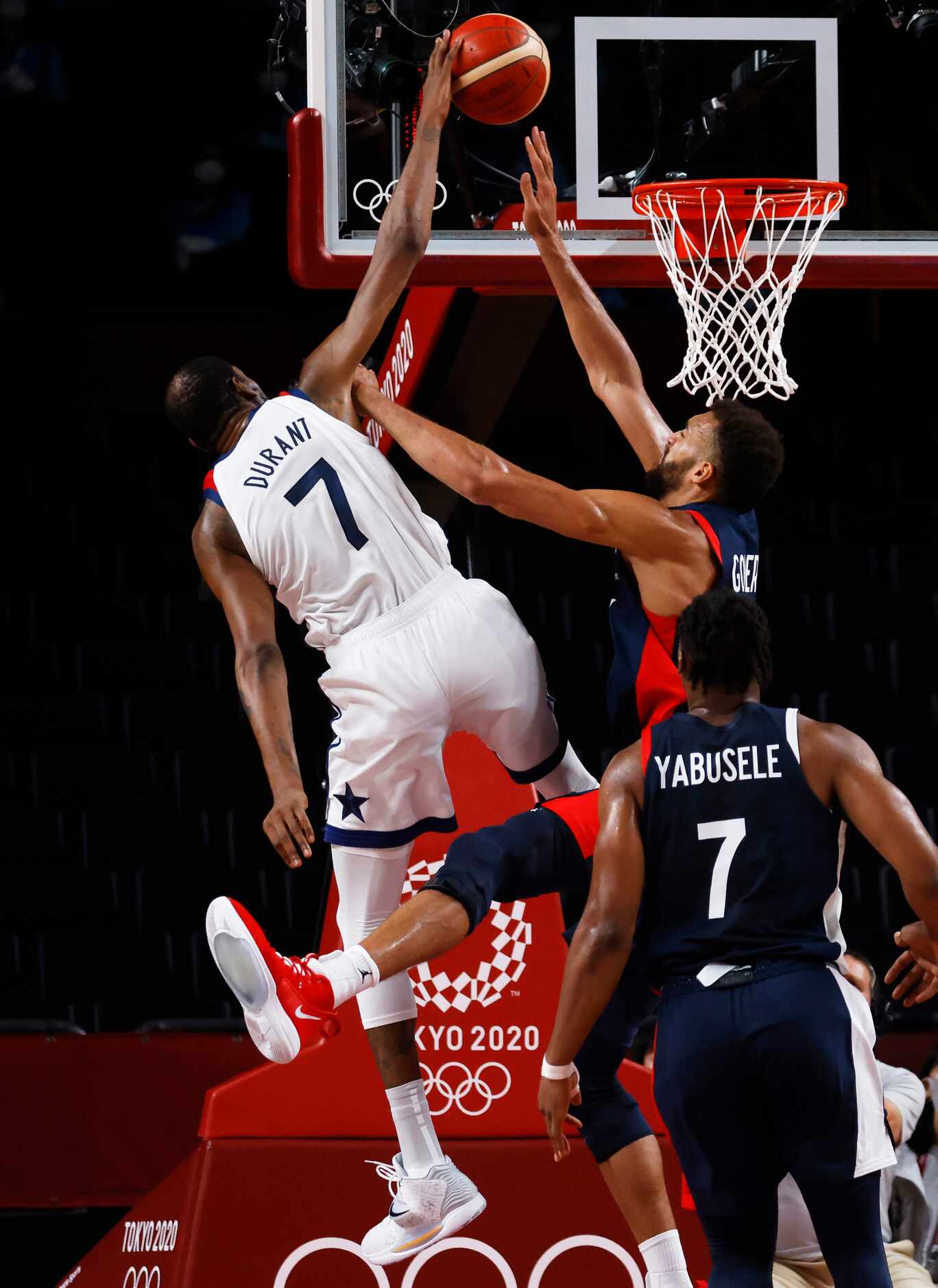 USA’s Kevin Durant (7) is fouled by France’s Rudy Gobert (27) on a shot attempt during the...