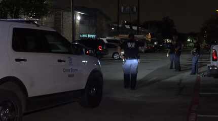 Investigators examine the scene of a fatal shooting at an apartment complex in the 12000...