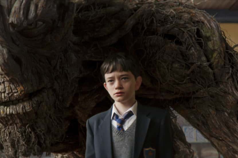 This image released by Focus Features, Lewis MacDougall appears with The Monster, voiced and...