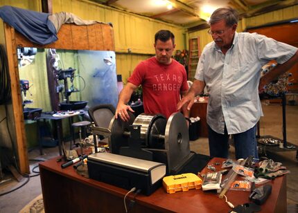 Brad Hunstable (left) and his father, Fred, go over the fine points of one of the their...