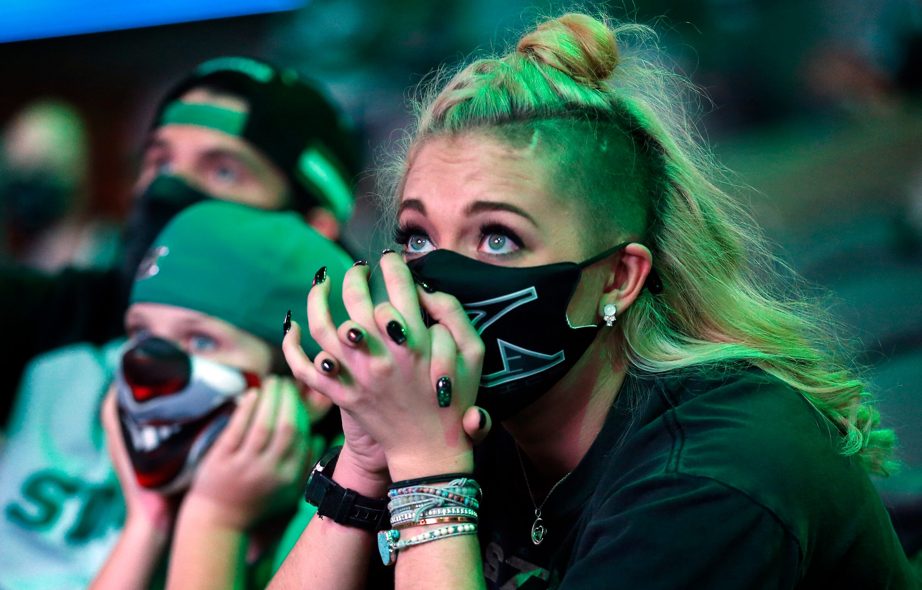 Dallas Stars fans Caty McColpin of Fort Worth is on the edge of her seat in overtime as she...