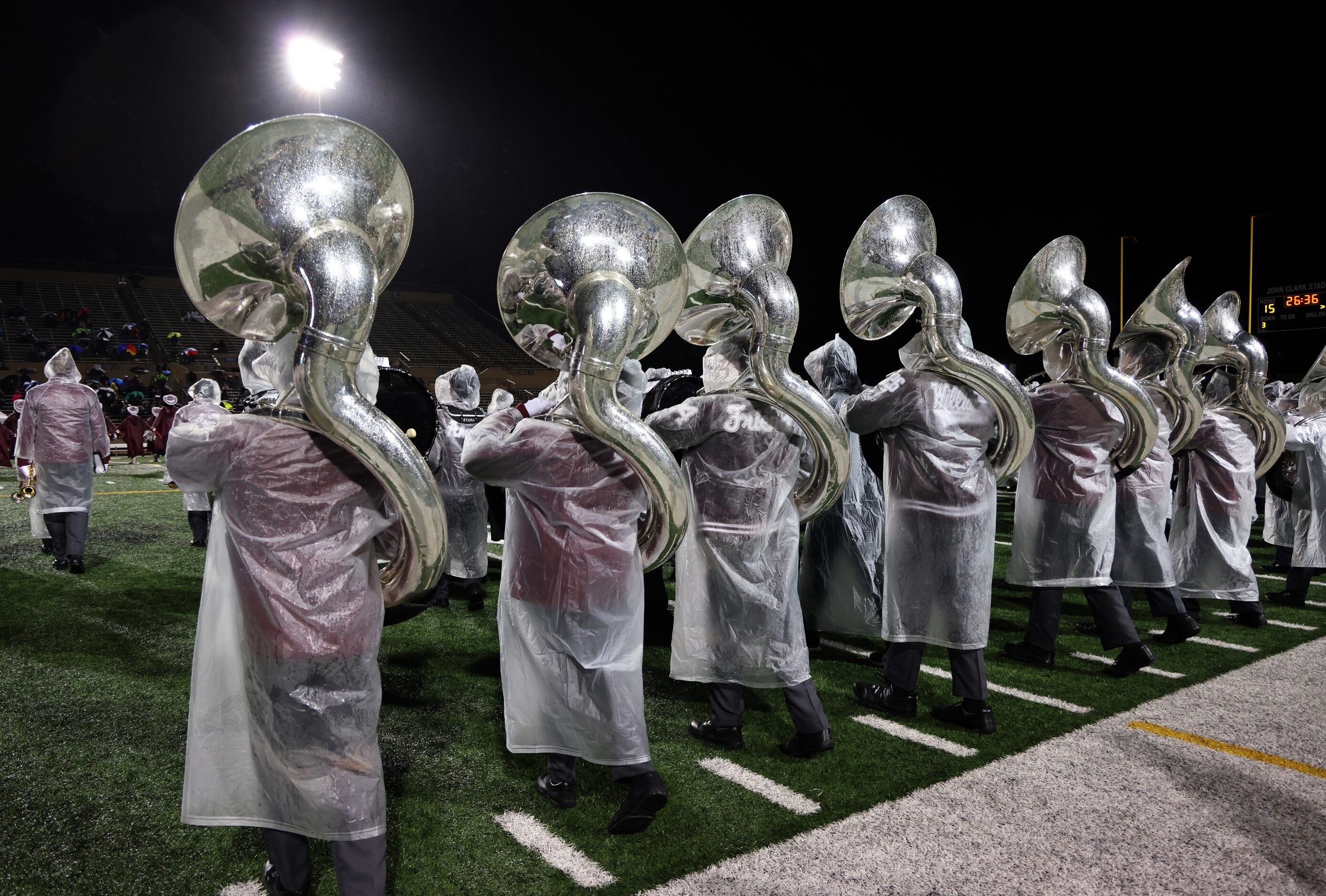 Members of the Lewisville band take to the field for their halftime performance midway...