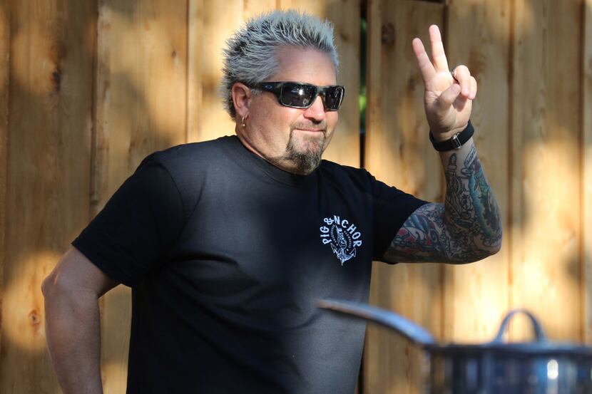 Guy Fieri plays to the crowd as he co-hosts Carnival's Kids BBQ Challenge at the State Fair...