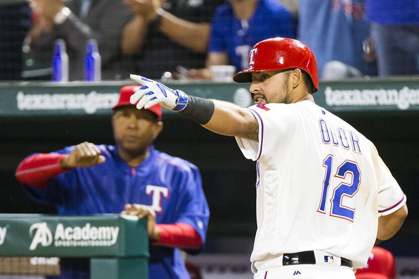 Texas Rangers second baseman Rougned Odor celebrates after scoring on a triple by shortstop...