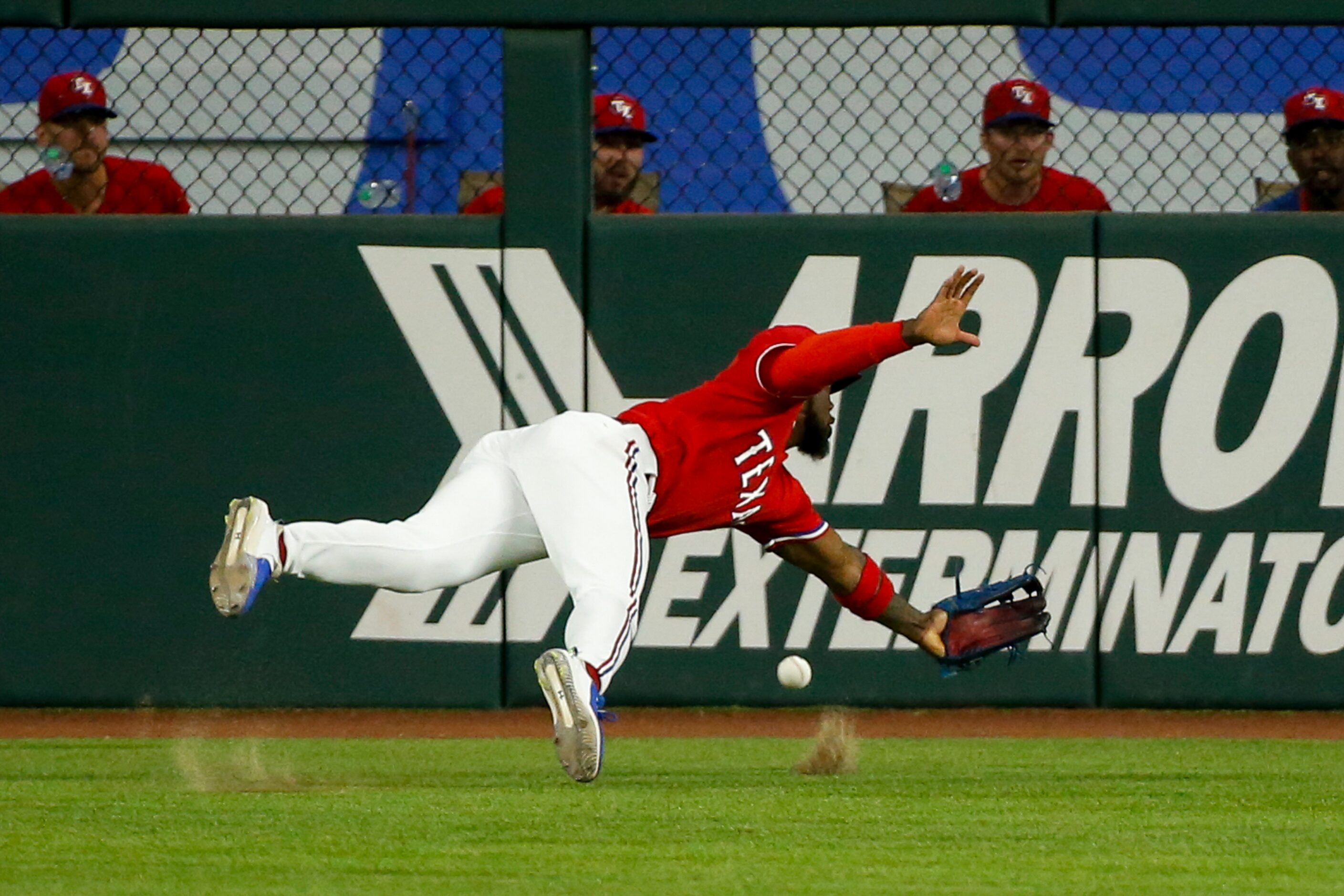 Texas Rangers center fielder Adolis Garcia (53) misplays the ball during the third inning...