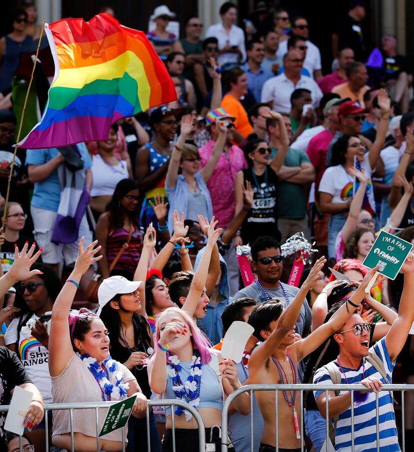 People gathered along the street outside Oak Lawn United Methodist Church to watch the pride...