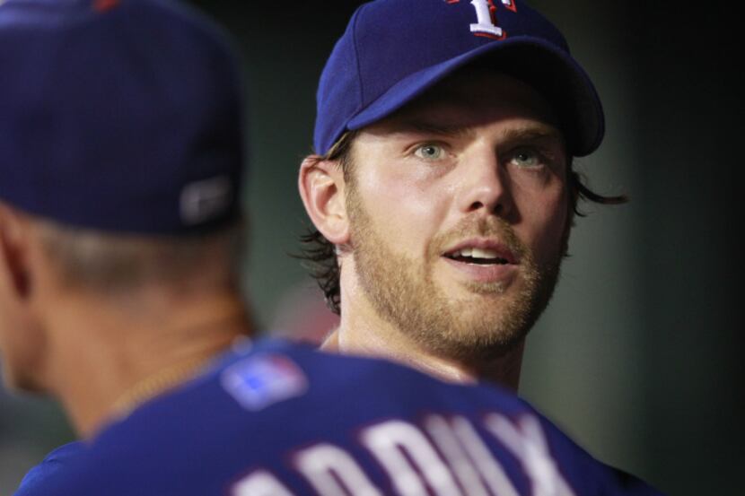 Texas pitcher Yu Darvish watches as Martin Perez flips the ball to a teammate during the...