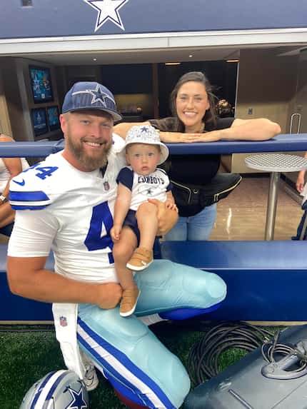 Cowboys long snapper Trent Sieg poses with his son, Eli, and wife, Carly, at AT&T Stadium.