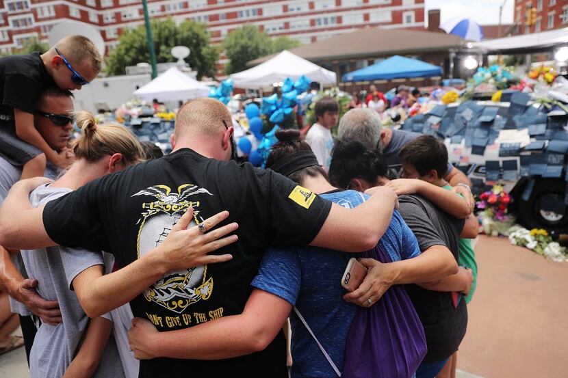 People visited a growing memorial at Dallas police headquarters Saturday. (Getty Images)