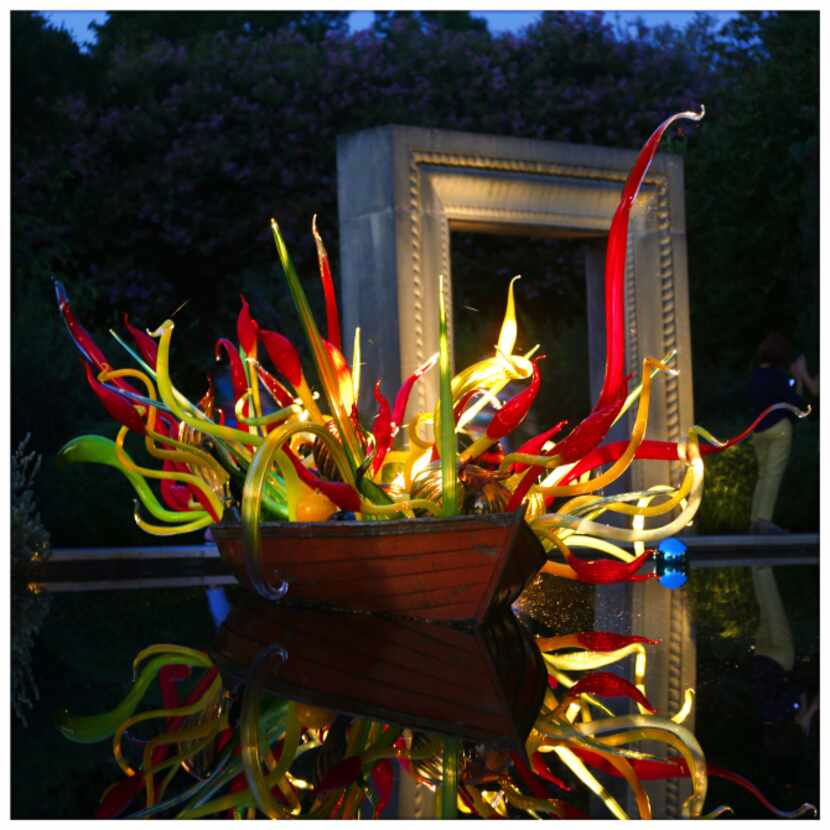 Chihuly's Carnival Boat is seen at dusk, at the Dallas Arboretum. Photographed with a Canon...