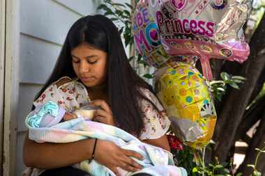 Jocelyne Tapia holds her 8-day-old newborn, Jalees, during a portrait session at her home in...