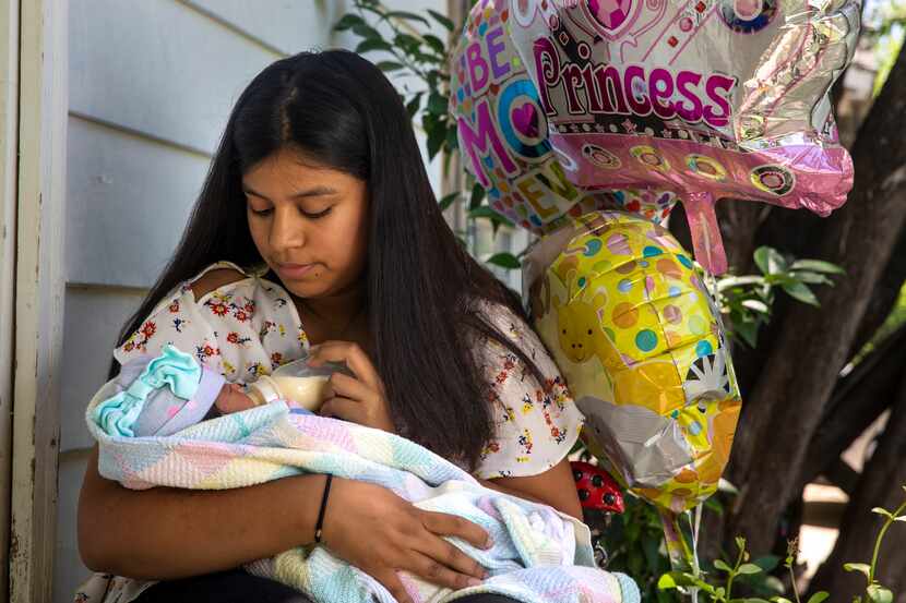Jocelyne Tapia holds her 8-day-old newborn, Jalees, during a portrait session at her home in...