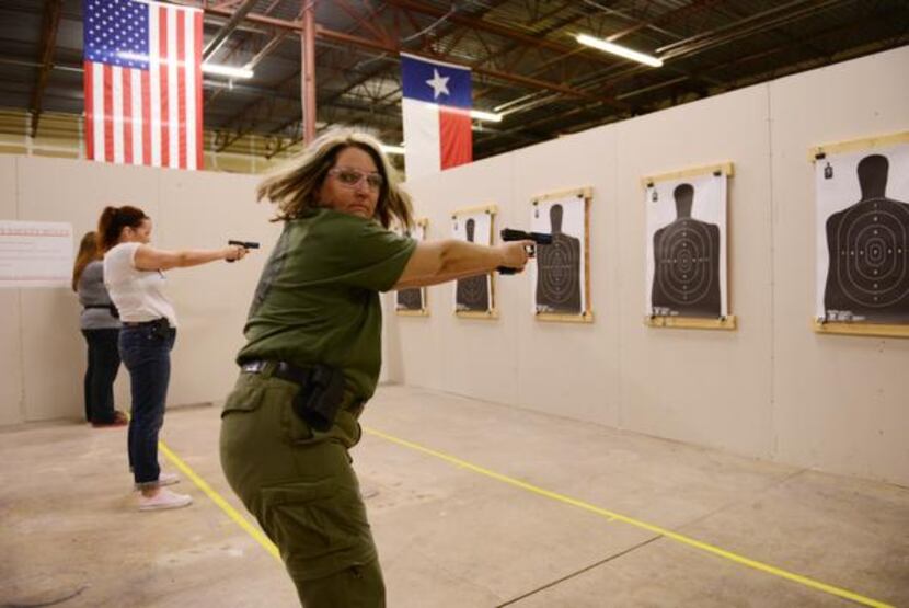 
Brenda Newby of Seagoville shoots a round of non-lethal ammunition during a women's...