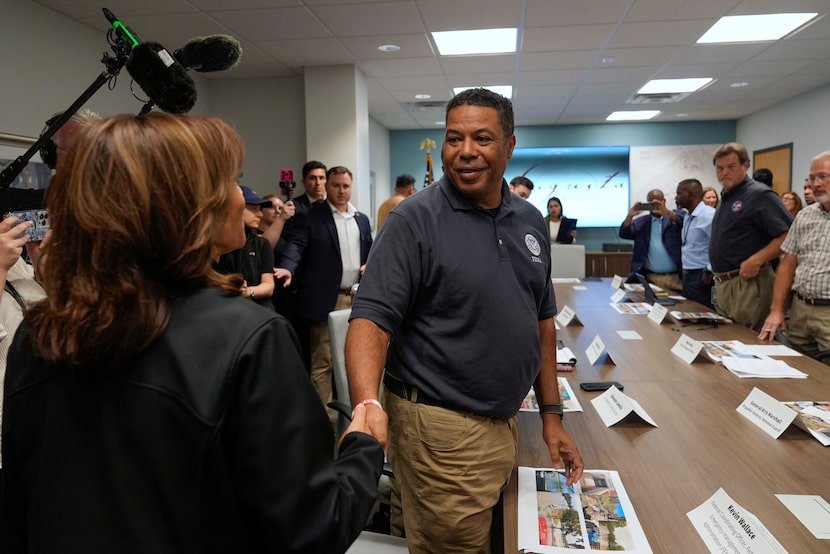 Vice President Kamala Harris greets FEMA worker Kevin Wallace before a briefing at the...