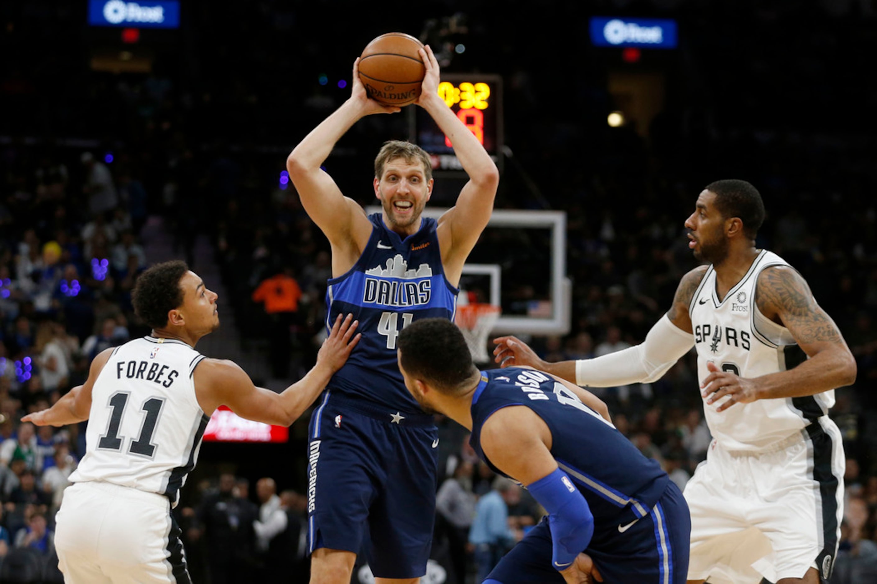 Dallas Mavericks forward Dirk Nowitzki (41) passes to teammate Jalen Brunson (13) between...