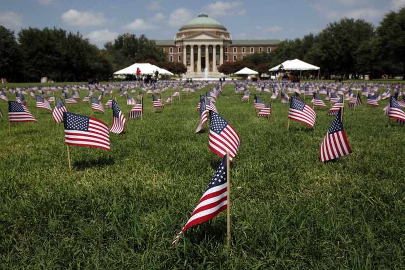 A display of 2,977 flags and 22 pairs of boots on September 10, 2010 on the SMU campus, each...