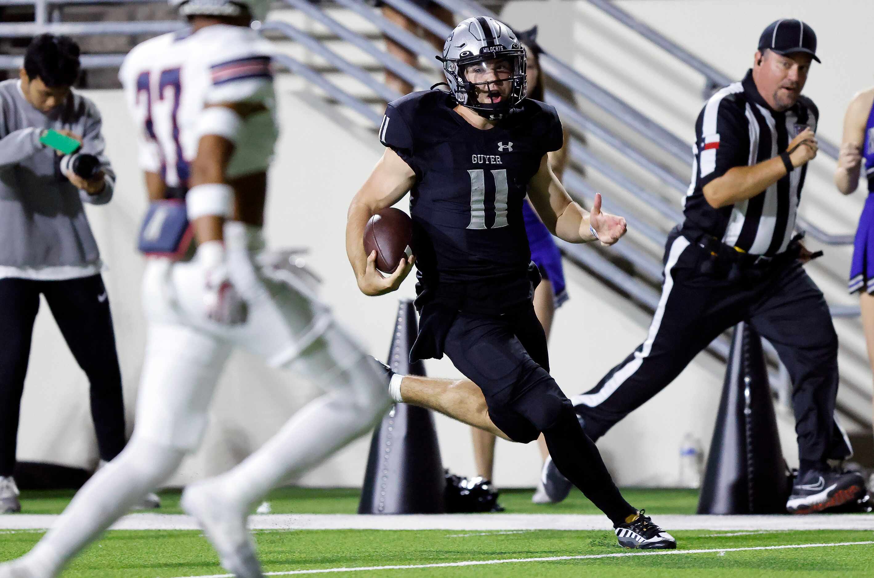 Denton Guyer quarterback Jackson Arnold (11) zig aged his way down the field running for a...