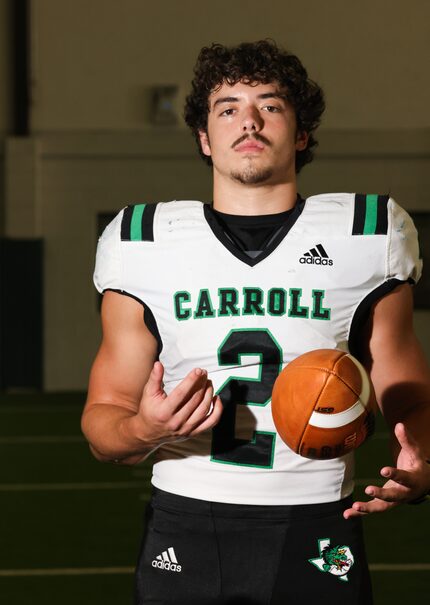 Southlake Carroll rising senior Owen Allen looks at the camera as he tosses a football...