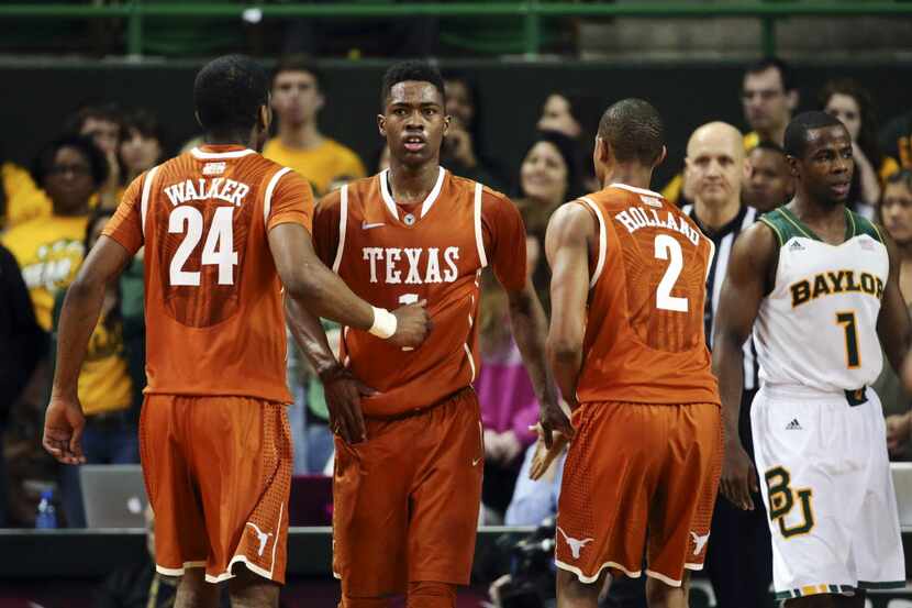 Texas guard Isaiah Taylor (1) is congratulated by guard Martez Walker (24) and guard...