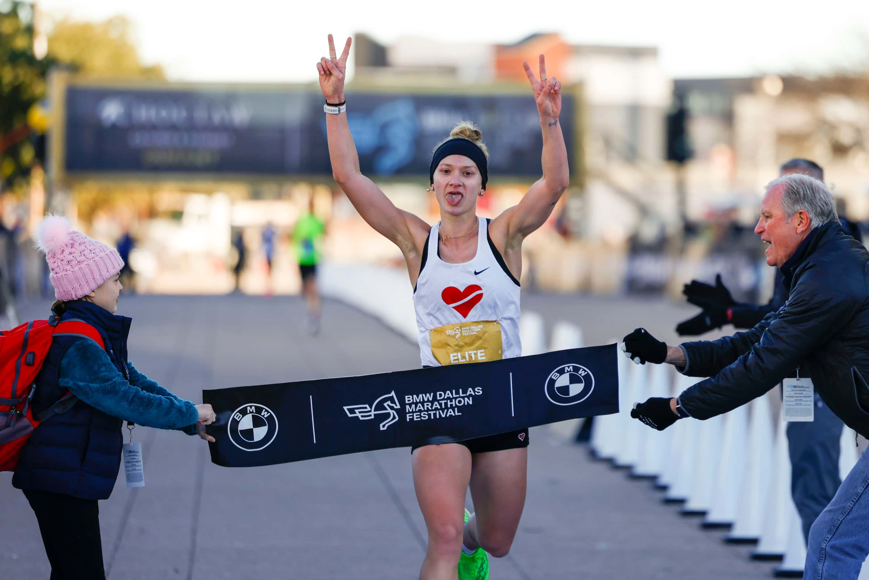 Women’s half marathon finisher Mimi Smith, 26, of Chicago, celebrates as she reaches the...