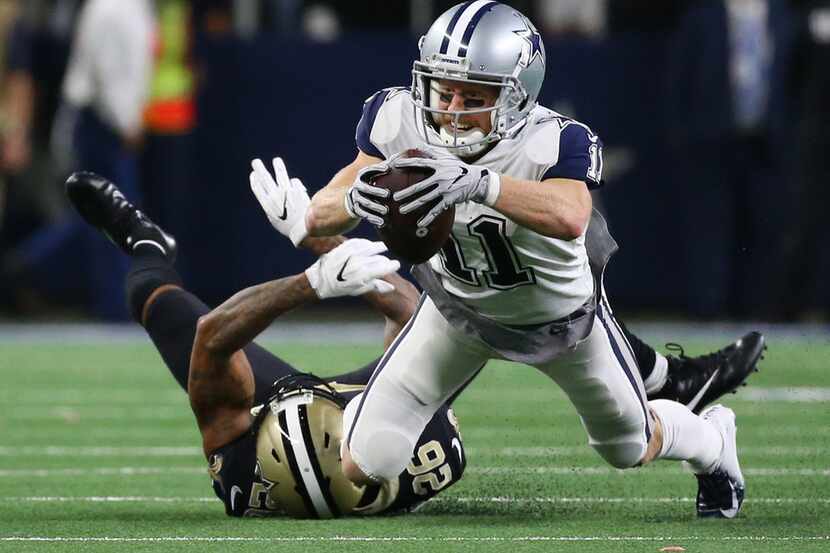 Dallas Cowboys wide receiver Cole Beasley (11) jumps for extra yardage against New Orleans...