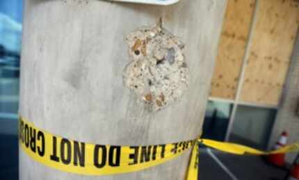  A concrete column outside Dallas police headquarters bears the mark of a .50-caliber bullet...