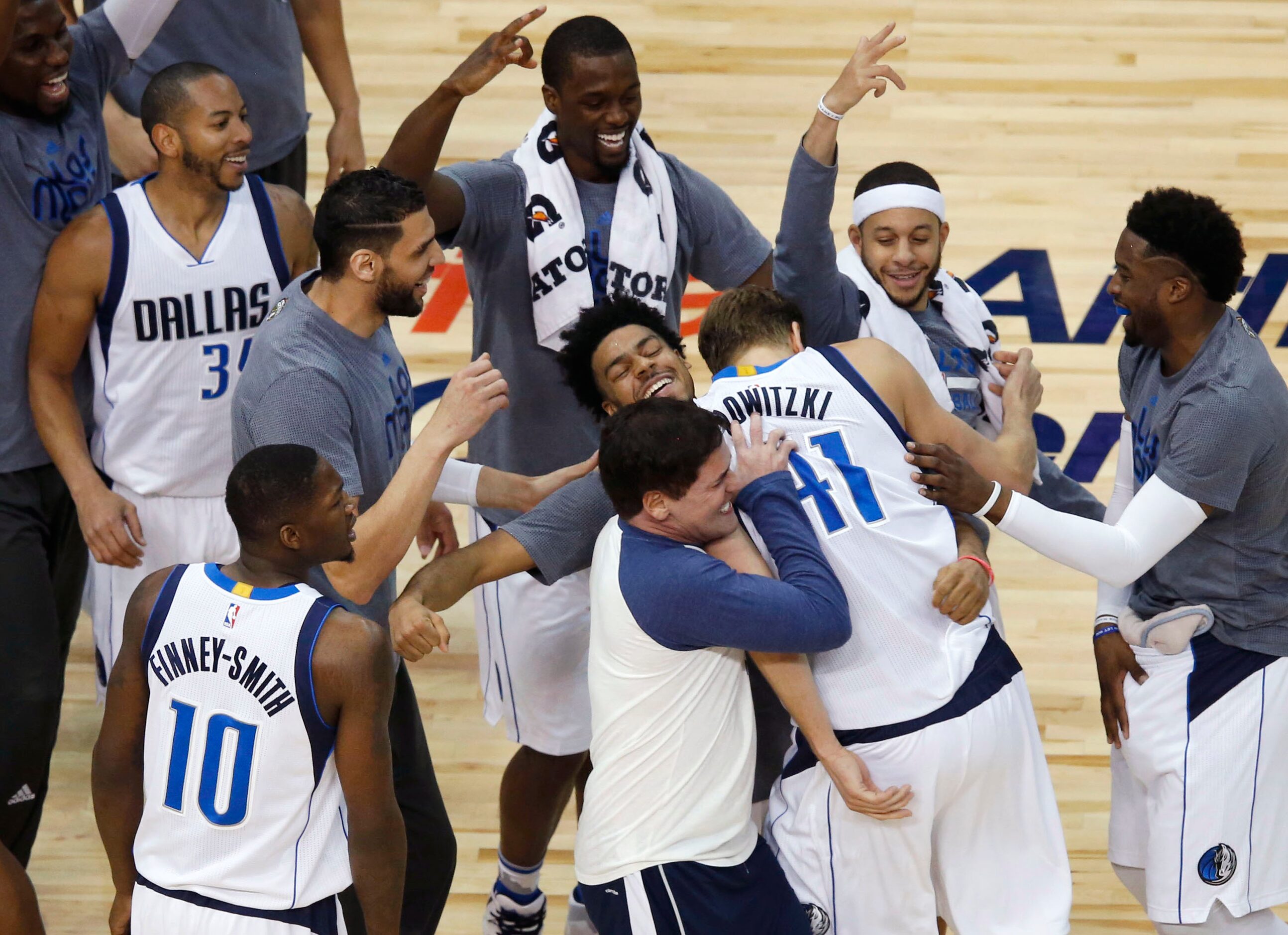 March 7, 2017: Dallas Mavericks forward Dirk Nowitzki (41) is congratulated by teammates and...