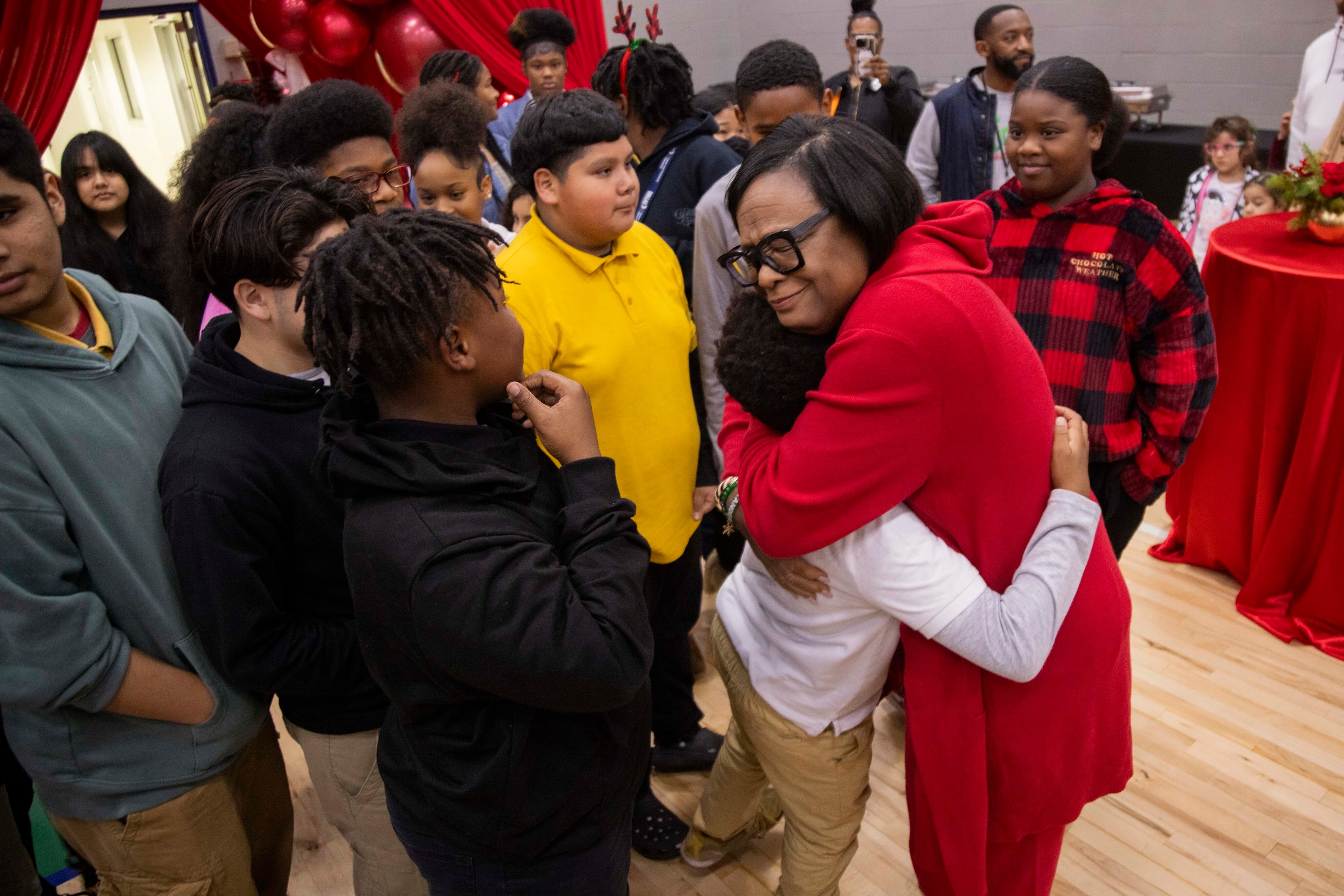 Cynt Marshall, chief executive officer of the Dallas Mavericks, hugs Dr. Frederick Douglass...