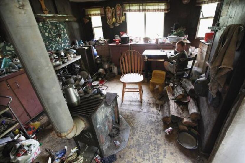 
Johnny Noble, 9, sits in his uncle’s trailer during a visit in Owsley County, Ky., a...