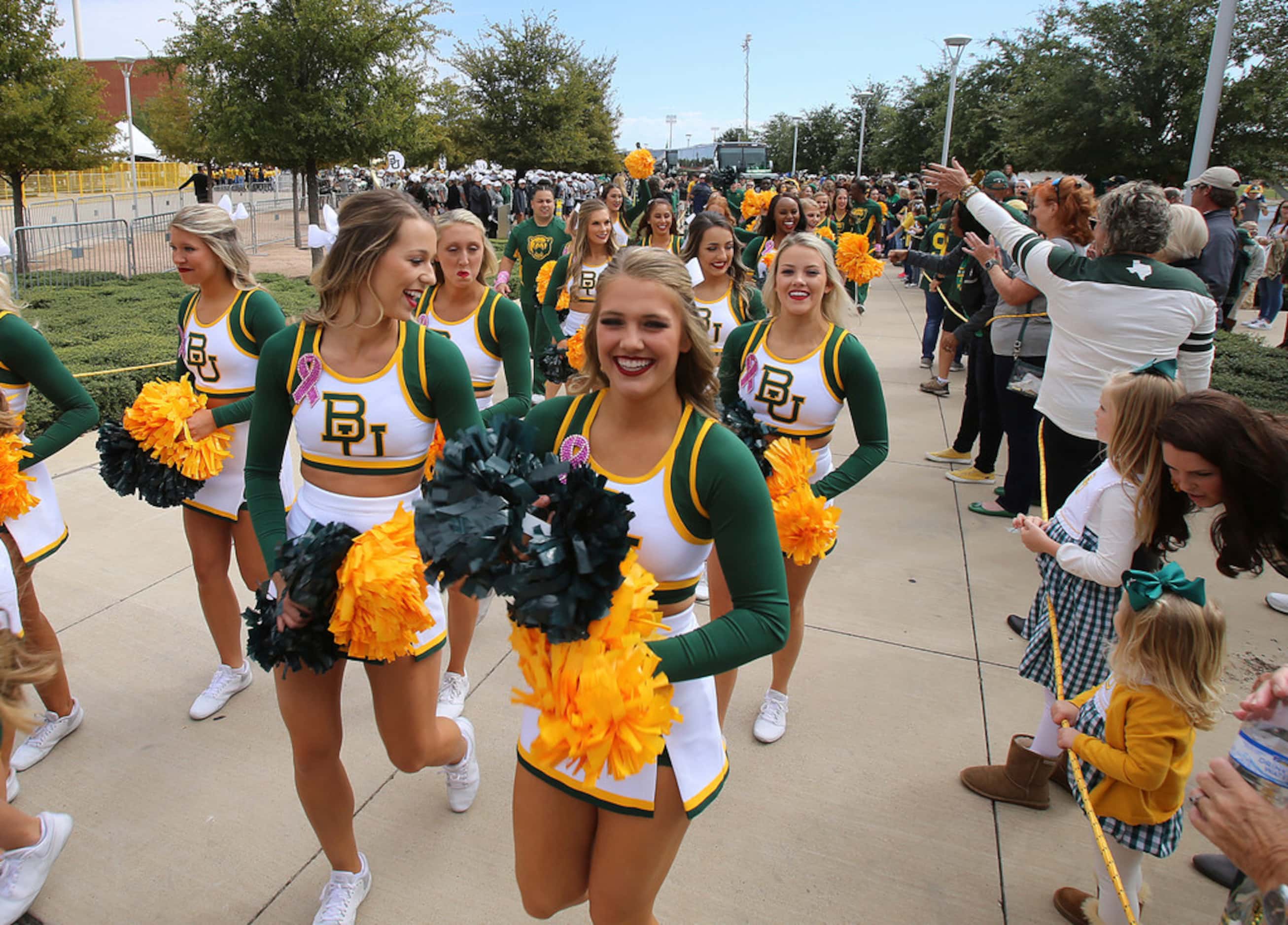 Baylor cheerleader greet the fans before the Baylor Texas Tech NCAA college football game in...