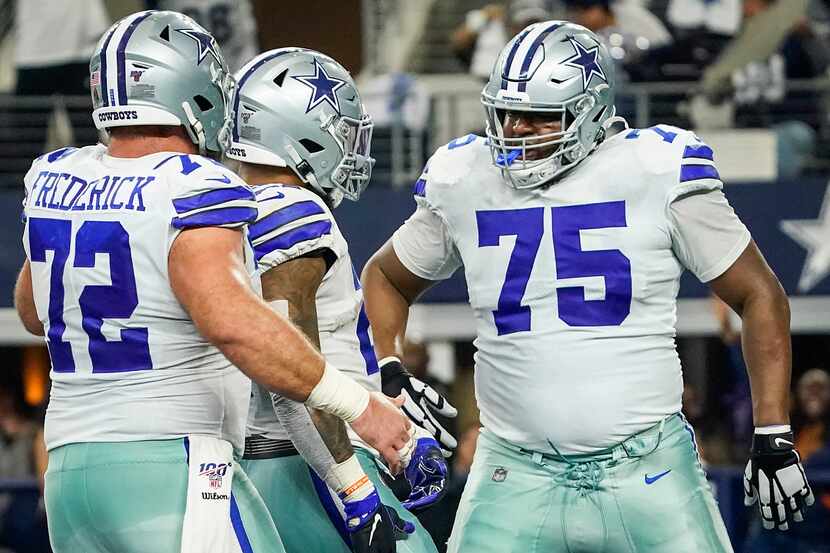 Dallas Cowboys running back Ezekiel Elliott (21) celebrates with offensive tackle Cameron...