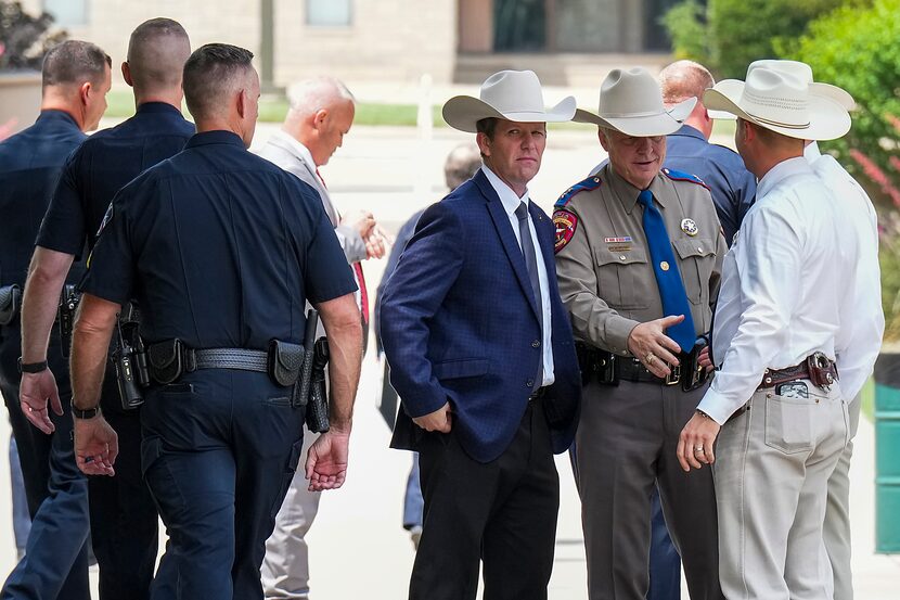 Hank Sibley, regional director of the Texas Department of Public Safety, reaches his hand...