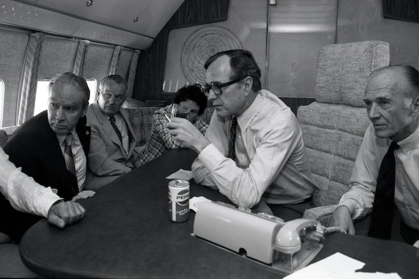 While Air Force Two refuels in Austin, Vice President George H.W. Bush watches the TV replay...