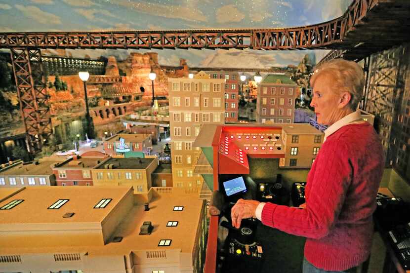 Jane Sanders runs the controls of the model train display that her husband, Stephen, had...
